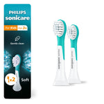 Two turquoise-and-white Philips Sonicare kids replacement brush heads shown next to product packaging panel on white background