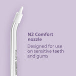 Clear Philips Sonicare N2 comfort flosser nozzle pictured on a purple background with text describing use for sensitive teeth and gums.