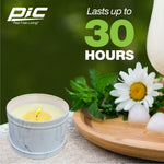 Lit marble-patterned PIC candle on a stone surface with chamomile flowers and text "Lasts up to 30 hours"