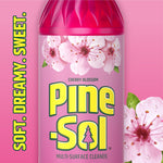 Close-up crop of a Pine-Sol Cherry Blossom bottle label with blossoms and bold Pine-Sol logo on pink background