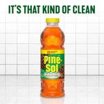 Single Pine-Sol bottle standing on a reflective tiled floor with headline text 'It's that kind of clean' above