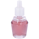Close-up of a clear glass fragrance refill bottle filled with pink liquid and topped with a white plastic cap and nozzle.