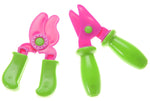 Pair of small pink-and-green plastic toy pruning shears shown isolated on a white background.