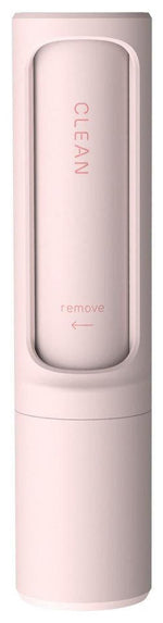 pink handheld lint remover with sliding cover labeled clean and an arrow marked remove