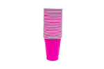 Stack of hot pink disposable plastic party cups with white rims on a white background