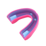 Pink outer shell mouthguard with purple and blue inner gel lining photographed on white background