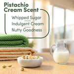 Styled scene showing folded towels, bowl of pistachios and a pitcher of milk with text describing pistachio cream scent notes