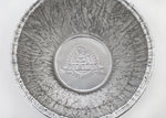 Top-down close-up of a Pit Boss foil bucket liner interior showing embossed Pit Boss logo on the bottom and crinkled aluminum texture.
