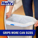 Hands placing a white Hefty trash bag with textured pattern into a grey rectangular can, Hefty logo at corner