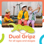 Group of children sitting outdoors with a large green Dual Gripz floss pick illustration and ‘Dual Gripz’ text