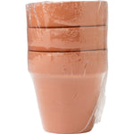 Stack of three small terra cotta pots wrapped in clear plastic packaging shown upright