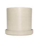 Cream cylindrical upcycled planter with matching saucer on white background, smooth subtle textured finish