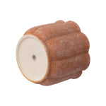 Terracotta scalloped planter shown on its side revealing the flat bottom with a central drainage hole and plug.