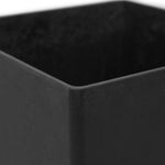 Corner close-up of a black square planter showing interior and exterior texture and rounded edge