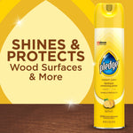 Pledge Expert Care lemon furniture polish aerosol can displayed beside graphic text 'Shines & Protects Wood Surfaces & More' on yellow background