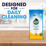 Pledge multisurface wipes pouch standing on a kitchen counter with text 'DESIGNED FOR DAILY CLEANING'.