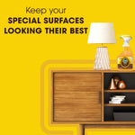 Styled interior scene with a Pledge wood oil spray bottle on a midcentury cabinet and headline about special surfaces