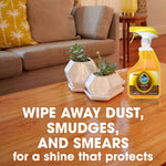 Living room tabletop scene with Pledge wood oil bottle on a polished wood coffee table and text about wiping away dust smudges