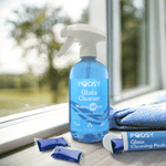 Podsy Glass Cleaner bottle on a windowsill with refill pods and cloth nearby