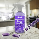 Podsy multi-surface cleaner spray bottle on a kitchen counter with purple liquid and refill pods nearby