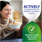 Woman eating cereal with adjacent text 'Actively to clean even the hardest-to-reach places' and a check mark graphic for stain removal.
