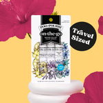 Poo-Pourri on-the-go travel spray pack displayed on a yellow background with floral accents and 'Travel Sized' badge