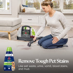 Woman using a portable carpet cleaner on a carpet stain with BISSELL spot-and-stain bottle inset and text about removing tough pet stains.
