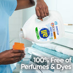 Person pouring all® free clear liquid detergent from a bottle into an orange measuring cap over a washer