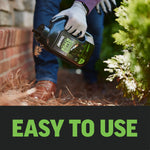 Close-up action shot of a person pouring Amdro Outdoor Roach Killer granules along a brick foundation next to plants
