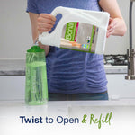 Person pouring Bona large refill jug into a clear green Bona refill bottle over a kitchen counter
