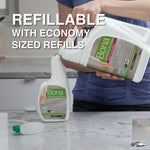 Person pouring a large Bona refill jug into a smaller Bona spray bottle on a kitchen counter with text 'refillable with economy sized refills'.