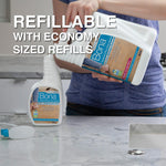 Person pouring a larger Bona refill into a Bona spray bottle on a kitchen counter with 'refillable' text overlay