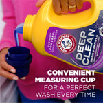 Close-up of someone pouring blue liquid from a yellow Arm & Hammer Deep Clean bottle into a measuring cap