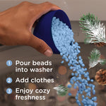 Hand pouring light blue laundry scent booster beads from a scoop with pine sprigs and three-step usage text overlay.