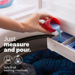 Hand pouring blue liquid from a red measuring cap into a washing machine dispenser with overlay text 'Just measure and pour'.