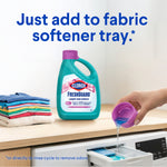 Product-in-use image showing Clorox FreshGuard bottle on counter while cap is poured into a washer fabric softener tray