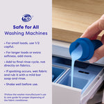 Photo of a hand pouring blue liquid from a measuring cap into a washer dispenser with usage instructions and HE-safe icon.