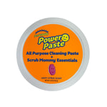 Top-down view of Scrub Daddy PowerPaste lid with bright orange label reading PowerPaste All Purpose Cleaning Paste