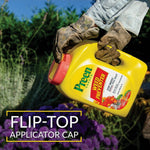 Gloved hands holding a Preen Garden Weed Preventer bottle tilted to show flip-top applicator cap
