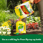 Person pouring Preen Garden Weed Preventer from a refill bag into a yellow flip-top Preen bottle in a garden setting