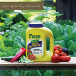 Preen Natural Vegetable Garden Weed Preventer jug on a bench with fresh produce and leafy greens behind, banner reads use up to day of harvest