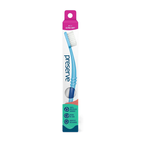 Single Preserve toothbrush in tall white blister-style box with blue curved handle and pink ultra soft header