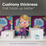 Shelved stacks of tissues with Puffs mascot character standing between larger and smaller stacks under product claim