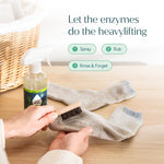 Hands scrubbing a sock with a small brush beside a Puracy Stain Remover spray bottle and laundry basket, with usage steps text above.
