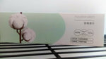 Front view of a PurCotton box showing cotton graphics and printed product details on a pale green and white package.