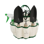Canvas gardening tote filled with three hand trowels, a spray bottle and tools