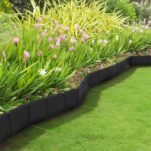 Black faux-cobbled garden edging panels installed along a flowerbed creating a curved border.