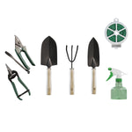 Laid-out gardening set showing trowel, rake, pruners, spray bottle and wire tie