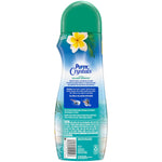 Back view of a Purex Crystals Fresh Island Breeze bottle showing product directions, ingredient panel, and a green cap.