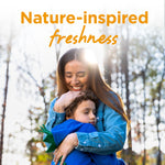 Mother hugging a child outdoors with overlay text 'Nature-inspired freshness' promoting Purex Crystals scent booster